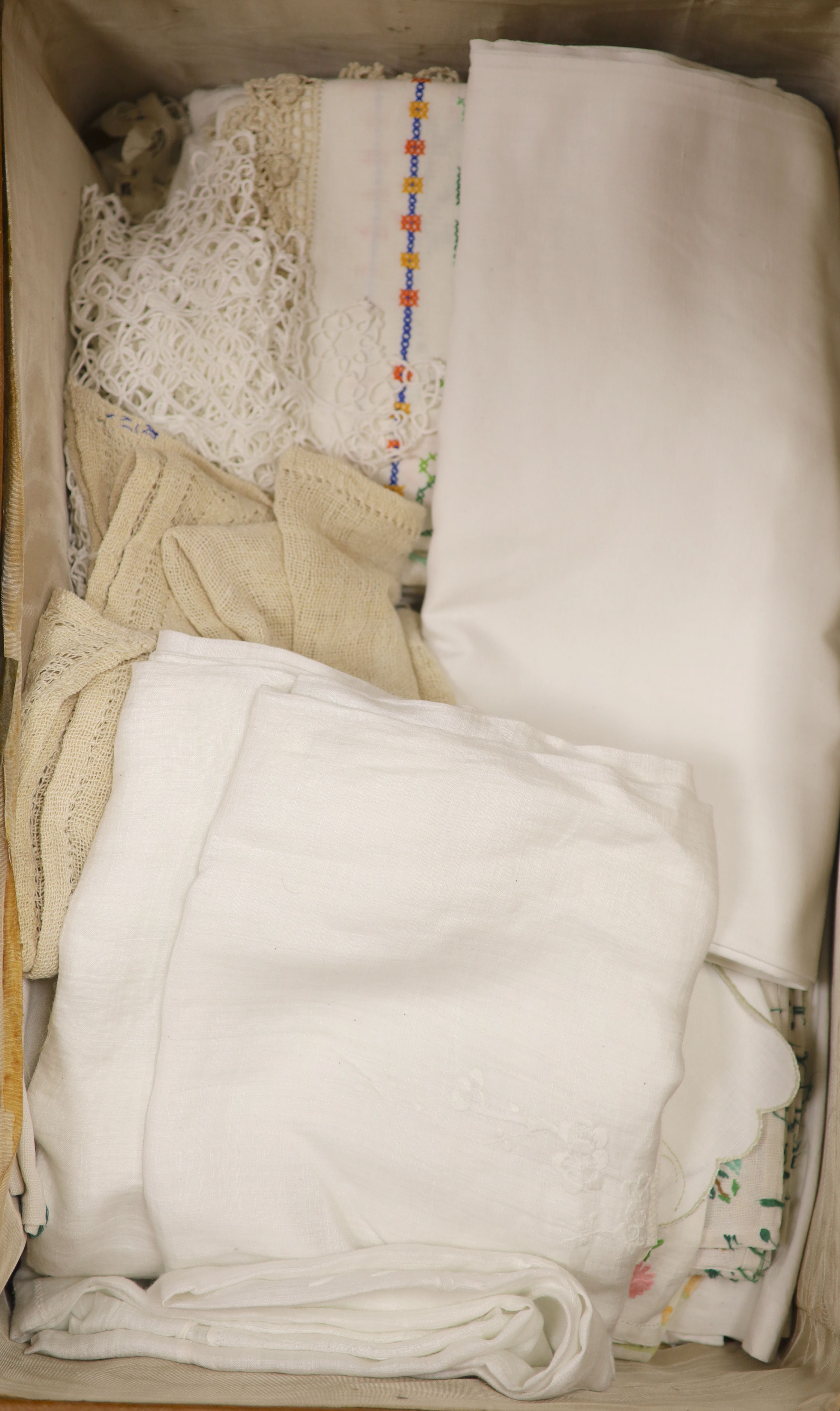 A suitcase of linen table cloths etc